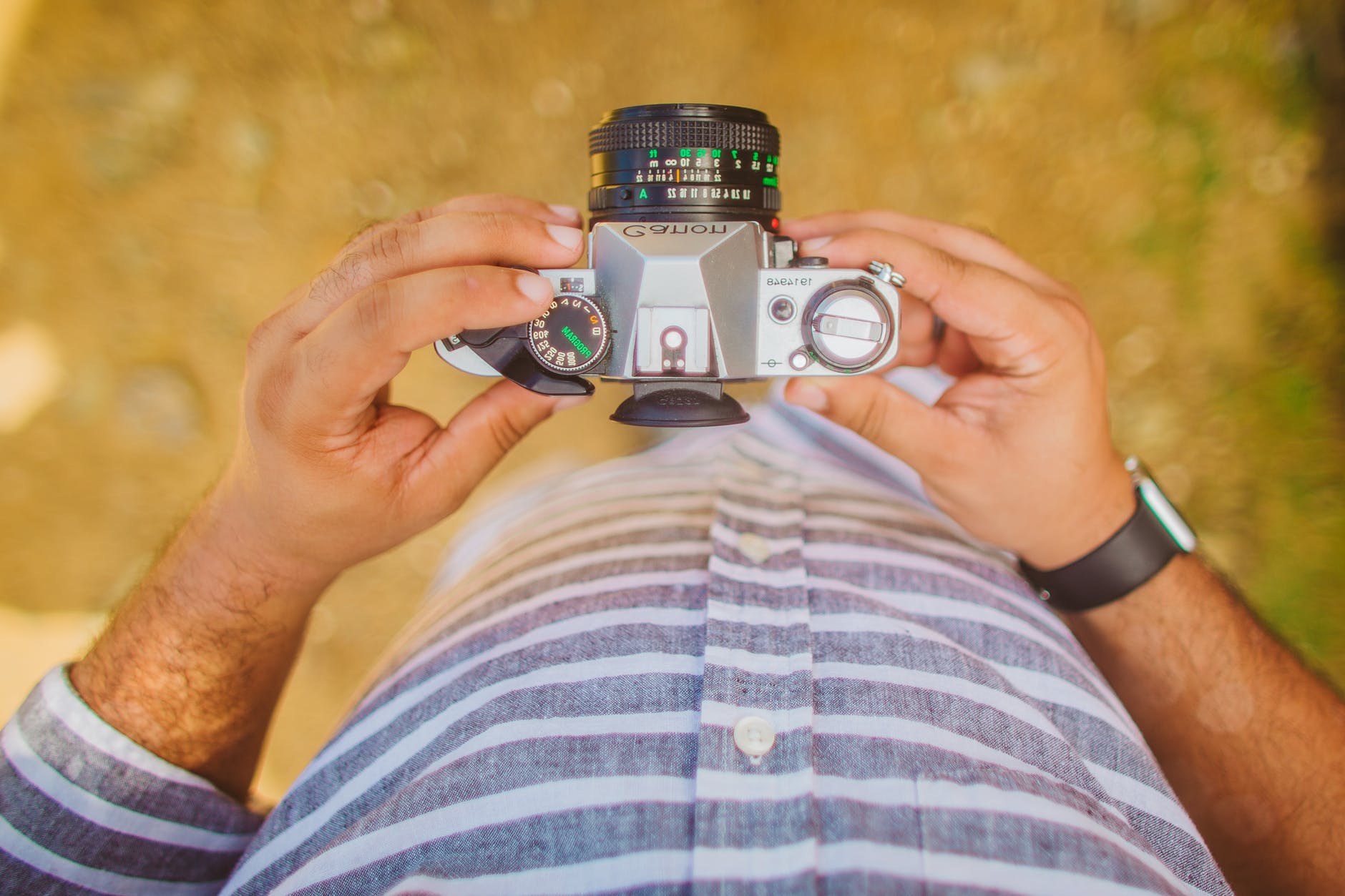 from above shot of man holding digital canon camera
